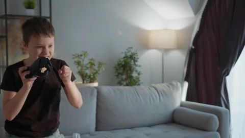 Boy Playing With Robotic Hand. Excited child futuristic gadget playful home Stock Footage 335478659