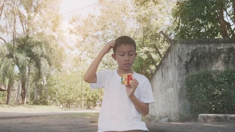 A boy playing with rubiks. Stock Footage 118877613