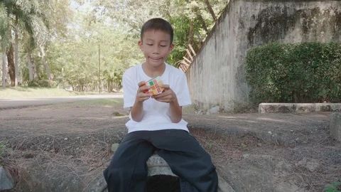 A boy playing with rubiks. Stock-Footage 118877659