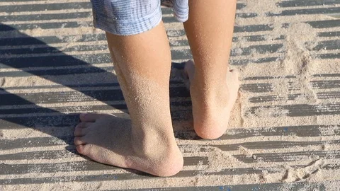 Boy playing with sand on the beach Stock Footage 116725832