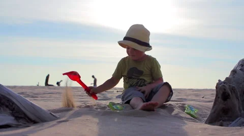 Boy playing in the sand Stock Footage 64209923