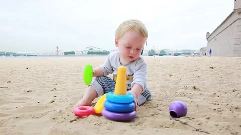 Boy playing in the sand Stock Footage 136229323