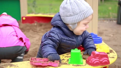Boy playing with sand molds Stock Footage 142144791
