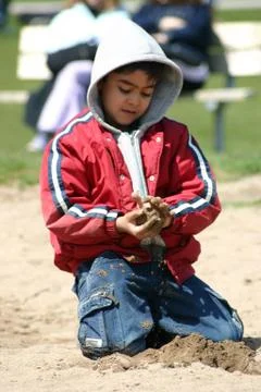 Boy playing in the sand Stock Photos