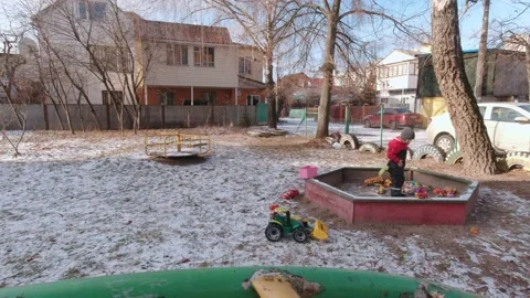 Boy Playing In The Sandbox In Winter Slow Motion Stock Footage 168925745