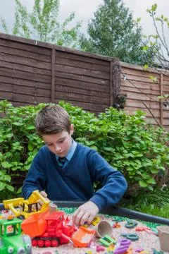 Boy playing in sandpit Stock Photos