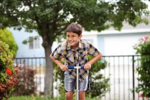 Boy playing on a scooter Stock Photos