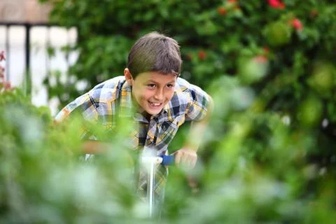 Boy playing on a scooter Stock Photos