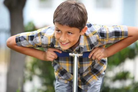 Boy playing on a scooter Stock Photos