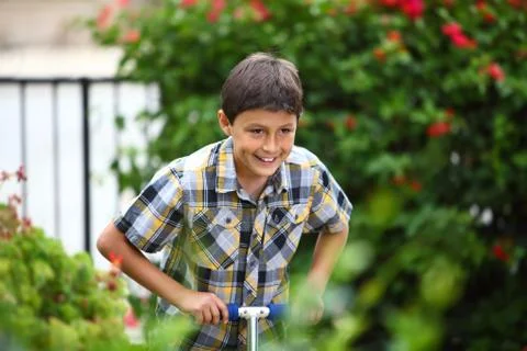 Boy playing on a scooter Stock Photos