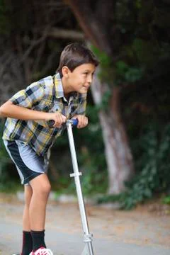 Boy playing on a scooter Stock Photos