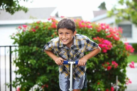 Boy playing on a scooter Stock Photos