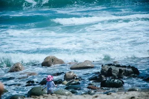 Boy playing on the seashore Stock Photos
