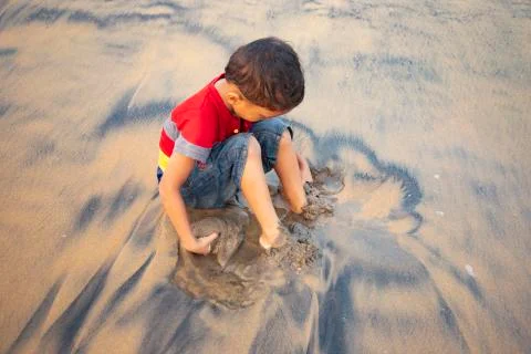 Boy playing at seashore Stock Photos