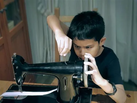 Boy Playing The Sewing Machine Stock Photos