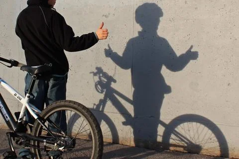 Boy playing with  shadow. Stock Photos