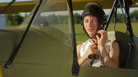 Boy playing sitting in old airplane Stock Footage 67460574