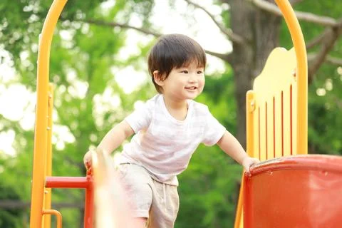 Boy playing on the slide Stock Photos