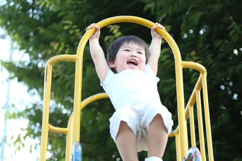 Boy playing on the slide Stock Photos