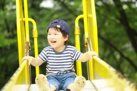 Boy playing on the slide Foto stock