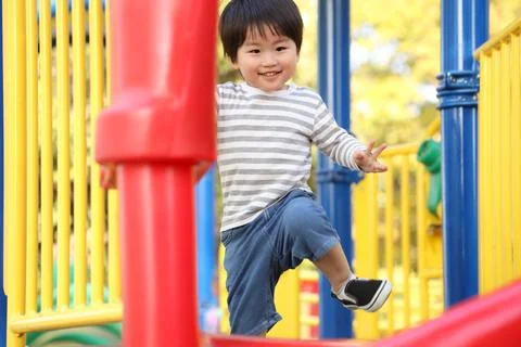 Boy playing on the slide Stock Photos