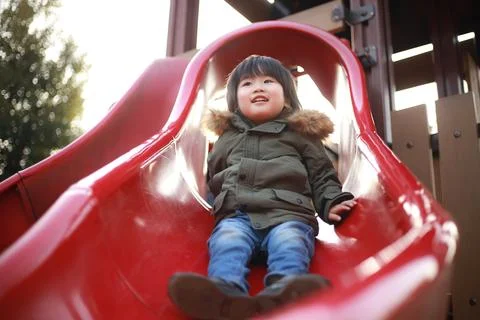 Boy playing on the slide ​ Stock Photos