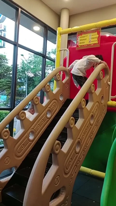 Boy is playing on a slide in the playground Stock Footage 278356402