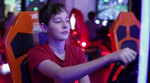 Boy playing on a slot machine simulator races Stock Footage 58194055