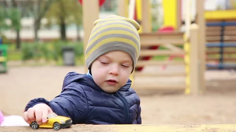 A boy is playing with a small car Video stock 163101137
