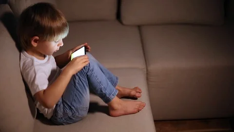 Boy playing with smart phone Stock Footage 102801269