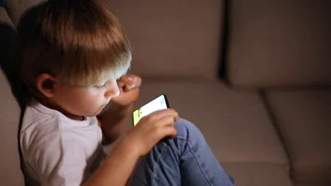 Boy playing with smart phone Stock Footage 102801358