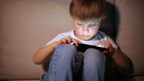 Boy playing with smart phone Stock Footage 102801463