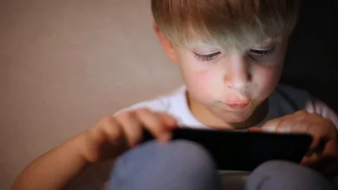Boy playing with smart phone Stock Footage 102801515