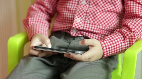 Boy is playing on the smartphone Stock Footage 74053093