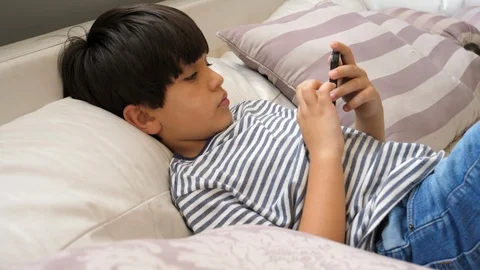 Boy playing Smartphone game Stock Footage 88908890