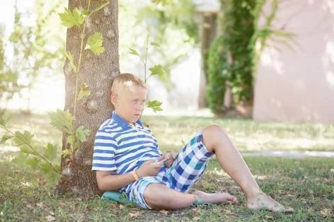 A boy playing on smartphone 写真素材