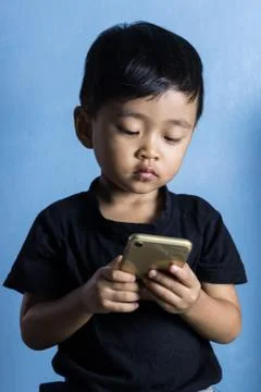 Boy playing smartphone Stock Photos