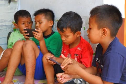 Boy is playing smartphone Stock Photos