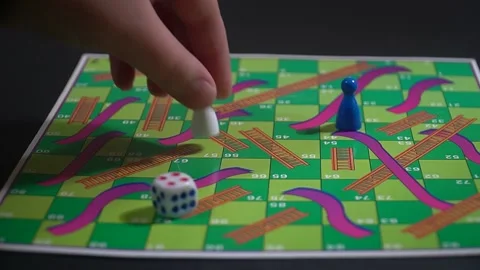 Boy playing snakes and ladders board game 库存影片 146915859