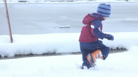 Boy playing in snow Stock Footage 11633969
