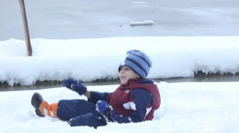 Boy playing in snow Stock Footage 11634110