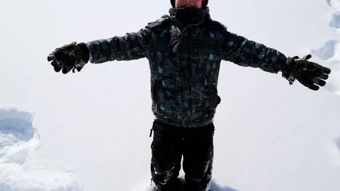 Boy playing in the snow Stock Footage 100181133