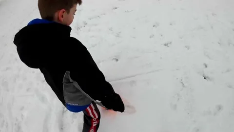 A boy is playing in the snow Stock Footage 155308870