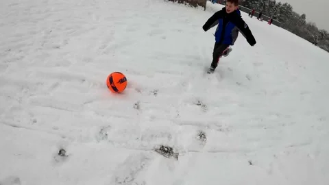 A boy is playing in the snow Stock Footage 155308879