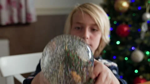 Boy playing with snow globe Stock Footage 219019977