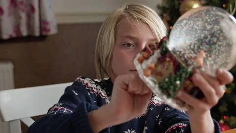 Boy playing with snow globe Stock Footage 219316322