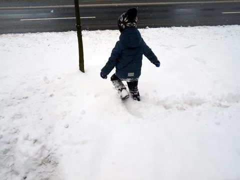A boy is playing in the snow Photos