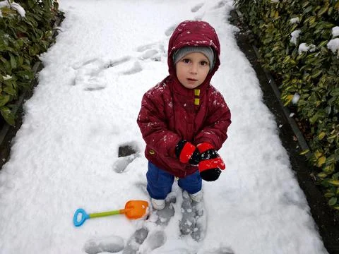 Boy playing in the snow Stock Photos