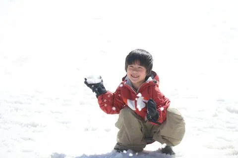 Boy playing in the snow Foto stock