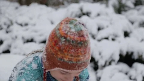Boy playing in the snow, throws a snowball at the camera. Stock Footage 70773963